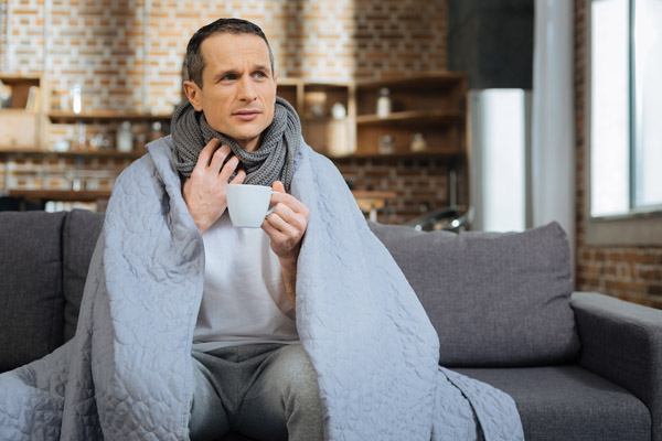 image of a homeowner feeling chilly due to incorrect furnace size