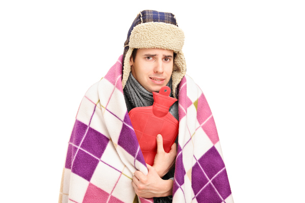 image of a homeowner feeling chilly due to uneven heating in home