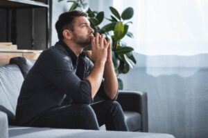 man thinking in the living room depicting concern for air duct condensation