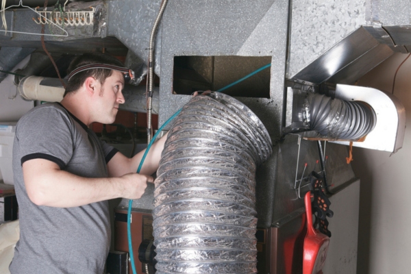 HVAC technician installing bigger ducts for the client