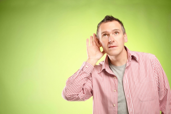 man with hand on ear depicting listening to ductwork noise