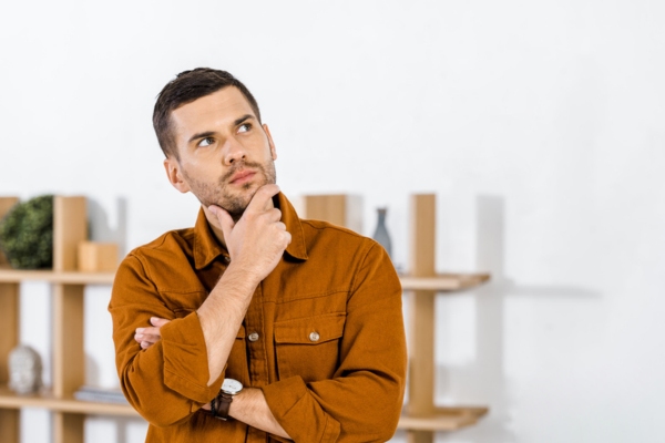 photo of man with hand on chin while thinking what AC short cycling means