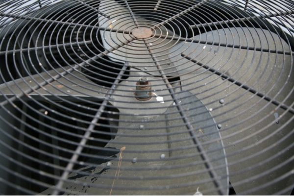 close up photo of an old and rusty air conditioner fan due to moisture and age