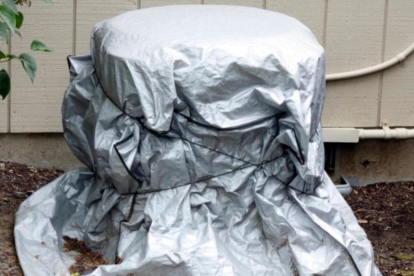 residential air conditioner unit with a silver cover