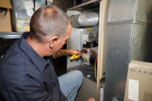 Modern Comfort HVAC technician servicing a furnace