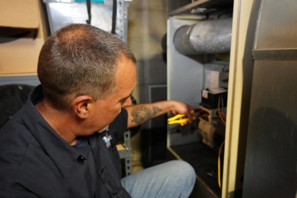 Modern Comfort HVAC technician doing furnace maintenance