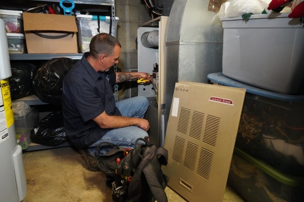 Modern Comfort HVAC technician doing furnace repair