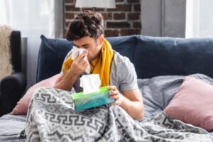 image of a sick man blowing nose depicting poor indoor air quality