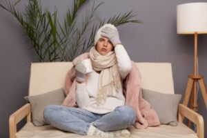 image of a woman feeling cold indoors due to broken furnace parts