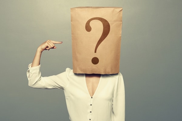 woman with paper bag on head pointing at question mark doodle depicting AFUE Rating meaning