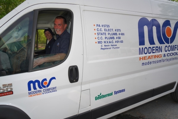 Modern Comfort HVAC technicians inside service van