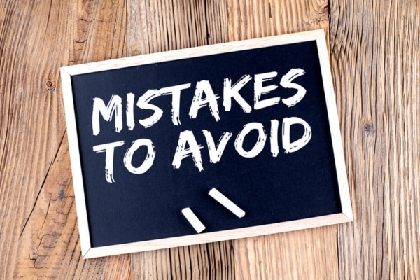 mistakes to avoid written on a chalkboard depicting habits that overwork your furnace