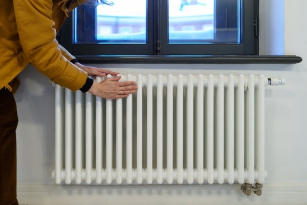 homeowner feeling a home heating radiator