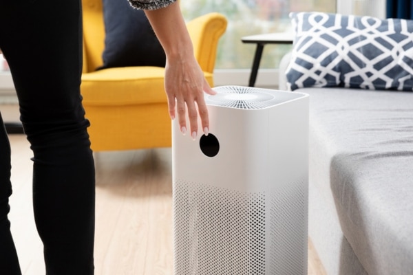 homeowner setting up portable air purifier