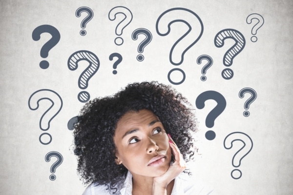 woman looking up with question mark drawings depicting FAQs about boiler replacement