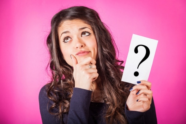 woman thinking while holding a question mark depicting improving air quality